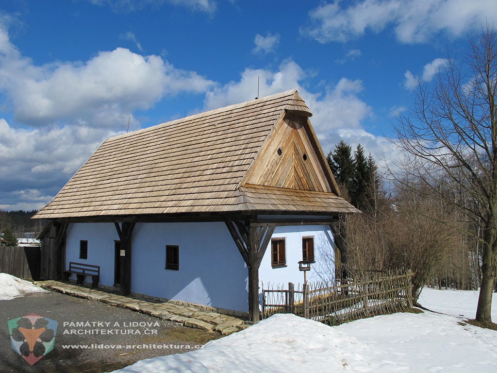 House with gabled roof having small conical roof at the top of the gable